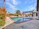 Backyard pool with red brick trim, privacy fence, BBQ, and lounge chairs under a pergola at 8450 E Montecito Ave, Scottsdale, AZ 85251