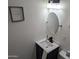 Clean bathroom featuring a vanity with a round mirror at 418 W Hartford Rd, Kearny, AZ 85137