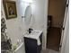 Bathroom with toilet, sink, and shower. View of bedroom in background at 418 W Hartford Rd, Kearny, AZ 85137