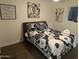 Well-lit bedroom featuring a double bed and modern wall art at 418 W Hartford Rd, Kearny, AZ 85137