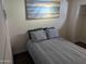 Bright bedroom with a double bed and ocean-themed artwork at 418 W Hartford Rd, Kearny, AZ 85137