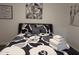 Well-lit bedroom featuring a double bed and modern wall art at 418 W Hartford Rd, Kearny, AZ 85137