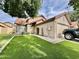 Single-Gathering home with manicured lawn, tile roof, desert landscaping, and a two-car garage at 4444 E Wildwood Dr, Phoenix, AZ 85048