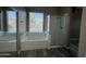 Bathroom featuring a large soaking tub with jets and a glass enclosed shower at 647 N Cambridge St, Gilbert, AZ 85233