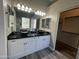 Bathroom with a dual sink vanity with black countertops and white cabinets at 647 N Cambridge St, Gilbert, AZ 85233