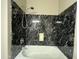 Bathtub with black tiled walls and shower head at 647 N Cambridge St, Gilbert, AZ 85233