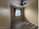 Bedroom with wood flooring and a ceiling fan and a window with gray curtains at 647 N Cambridge St, Gilbert, AZ 85233