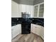 White cabinets surround stainless steel microwave and black gas range at 647 N Cambridge St, Gilbert, AZ 85233