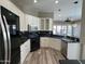 Modern kitchen with black countertops, stainless steel appliances, and white cabinets at 647 N Cambridge St, Gilbert, AZ 85233