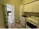 Laundry room with washer and dryer, and cabinets and doorway view to kitchen at 647 N Cambridge St, Gilbert, AZ 85233