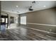 Open-concept living room with wood floors and modern lighting fixture at 647 N Cambridge St, Gilbert, AZ 85233