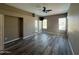 Large living room with wood flooring and a ceiling fan and windows on two walls at 647 N Cambridge St, Gilbert, AZ 85233