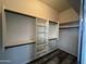 Walk-in closet features custom shelving and wood-look flooring at 647 N Cambridge St, Gilbert, AZ 85233