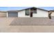 Charming single-story home featuring a low-maintenance gravel front yard and solar panels on the roof at 834 W Isabella Ave, Mesa, AZ 85210