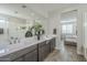 Spa-like bathroom with double sinks, large mirror and a view into the bedroom at 12107 N San Clemente St, Surprise, AZ 85388