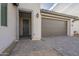 Gray two-car garage and walkway to front entrance at 12107 N San Clemente St, Surprise, AZ 85388