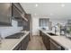 Modern kitchen with gray cabinets, quartz countertops, and stainless steel appliances at 12107 N San Clemente St, Surprise, AZ 85388