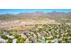 Expansive aerial view of a vibrant neighborhood featuring lush greenery, sports facilities, and scenic mountain views at 15380 N 100Th St # 1106, Scottsdale, AZ 85260