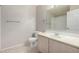 Bathroom featuring a large mirror, single sink vanity, toilet, tiled floors, and towel rack at 15380 N 100Th St # 1106, Scottsdale, AZ 85260