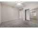 Bedroom features a sliding mirrored closet with a view, plush carpeting, and neutral walls at 15380 N 100Th St # 1106, Scottsdale, AZ 85260