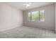 The bedroom has neutral colored carpet with a large window to allow light at 15380 N 100Th St # 1106, Scottsdale, AZ 85260