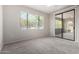 The bedroom has neutral colored carpet and a glass door that opens to a patio at 15380 N 100Th St # 1106, Scottsdale, AZ 85260