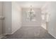 Dining area with chandelier lighting, neutral walls, and carpet flooring at 15380 N 100Th St # 1106, Scottsdale, AZ 85260