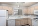 Bright kitchen with white appliances, light-colored cabinets and a window at 15380 N 100Th St # 1106, Scottsdale, AZ 85260