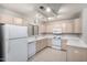Bright kitchen with white appliances and light-colored cabinets with lots of lighting at 15380 N 100Th St # 1106, Scottsdale, AZ 85260