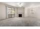 Spacious living room with plush carpeting, fireplace, and sliding glass doors to the patio at 15380 N 100Th St # 1106, Scottsdale, AZ 85260