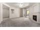 Bright living room with neutral tones, cozy fireplace, and a sliding glass door to a private balcony at 15380 N 100Th St # 1106, Scottsdale, AZ 85260