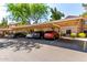 Parking lot in front of a two story condo complex with a car port covering the parking spaces at 15380 N 100Th St # 1106, Scottsdale, AZ 85260