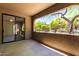 Spacious outdoor patio featuring stucco walls, concrete floors, and a sliding glass door entrance at 15380 N 100Th St # 1106, Scottsdale, AZ 85260