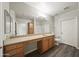 Bathroom featuring dual sinks, vanity, and a large mirror at 14575 W Mountain View Blvd # 11113, Surprise, AZ 85374