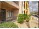 Attractive condo building with a charming patio area, desert landscaping, and convenient covered parking at 14575 W Mountain View Blvd # 11113, Surprise, AZ 85374