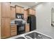 Kitchen features wood cabinets, black appliances, and modern fixtures at 14575 W Mountain View Blvd # 11113, Surprise, AZ 85374
