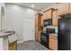 Well-lit kitchen features wood cabinets and modern appliances at 14575 W Mountain View Blvd # 11113, Surprise, AZ 85374