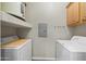 Laundry room with washer, dryer, and shelving for storage at 14575 W Mountain View Blvd # 11113, Surprise, AZ 85374