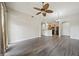 Open-concept living room with wood flooring and ceiling fan at 14575 W Mountain View Blvd # 11113, Surprise, AZ 85374