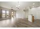 Bright living room with elegant flooring, natural light, and stylish fixtures for a warm, inviting space at 14575 W Mountain View Blvd # 11113, Surprise, AZ 85374