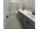 Contemporary bathroom with double vanity, sleek fixtures, and a tub with shower at 25204 W Wayland Dr, Buckeye, AZ 85326