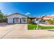 Charming single-story home with a well-manicured front yard and a spacious two-car garage at 5038 W Echo Ln, Glendale, AZ 85302