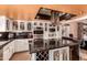 Well-equipped kitchen featuring custom cabinetry, an island with countertop seating, and stainless appliances at 5038 W Echo Ln, Glendale, AZ 85302