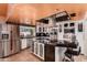 Contemporary kitchen with stainless steel appliances, a center island, and custom cabinetry at 5038 W Echo Ln, Glendale, AZ 85302