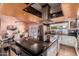 Modern kitchen with stainless steel appliances, island with countertop seating, and a dining area at 5038 W Echo Ln, Glendale, AZ 85302