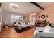 Bright living room features hardwood floors, a vaulted ceiling, and stylish modern furnishings at 5038 W Echo Ln, Glendale, AZ 85302