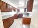 Galley style kitchen with granite countertops and dark wood cabinets at 6102 S 101St Dr, Tolleson, AZ 85353