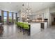 Bright, modern kitchen offers generous island seating and sleek design with stainless steel appliances at 11946 E Cavedale Dr, Scottsdale, AZ 85262