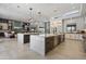 Modern kitchen features dual islands, stainless steel appliances, and an open layout to the living area at 11946 E Cavedale Dr, Scottsdale, AZ 85262