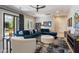 Comfortable living room with plush blue sectional, modern décor, and stylish area rug at 11946 E Cavedale Dr, Scottsdale, AZ 85262